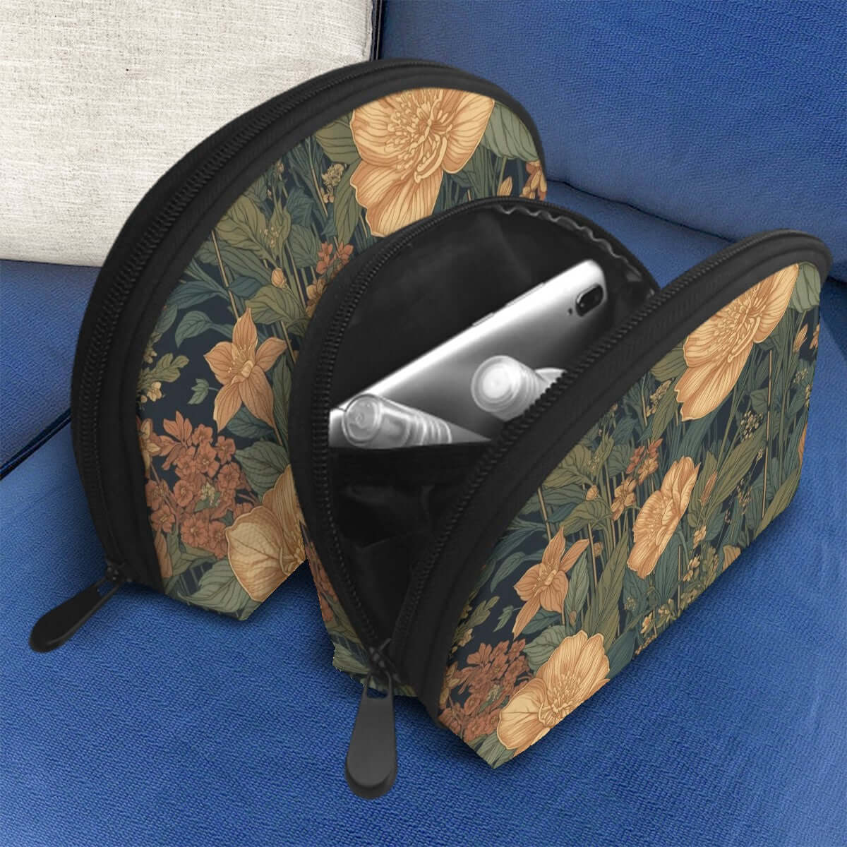 Floral design Storage Bags Set of 2 on sofa, large and small sizes with zipper open showing interior compartments.