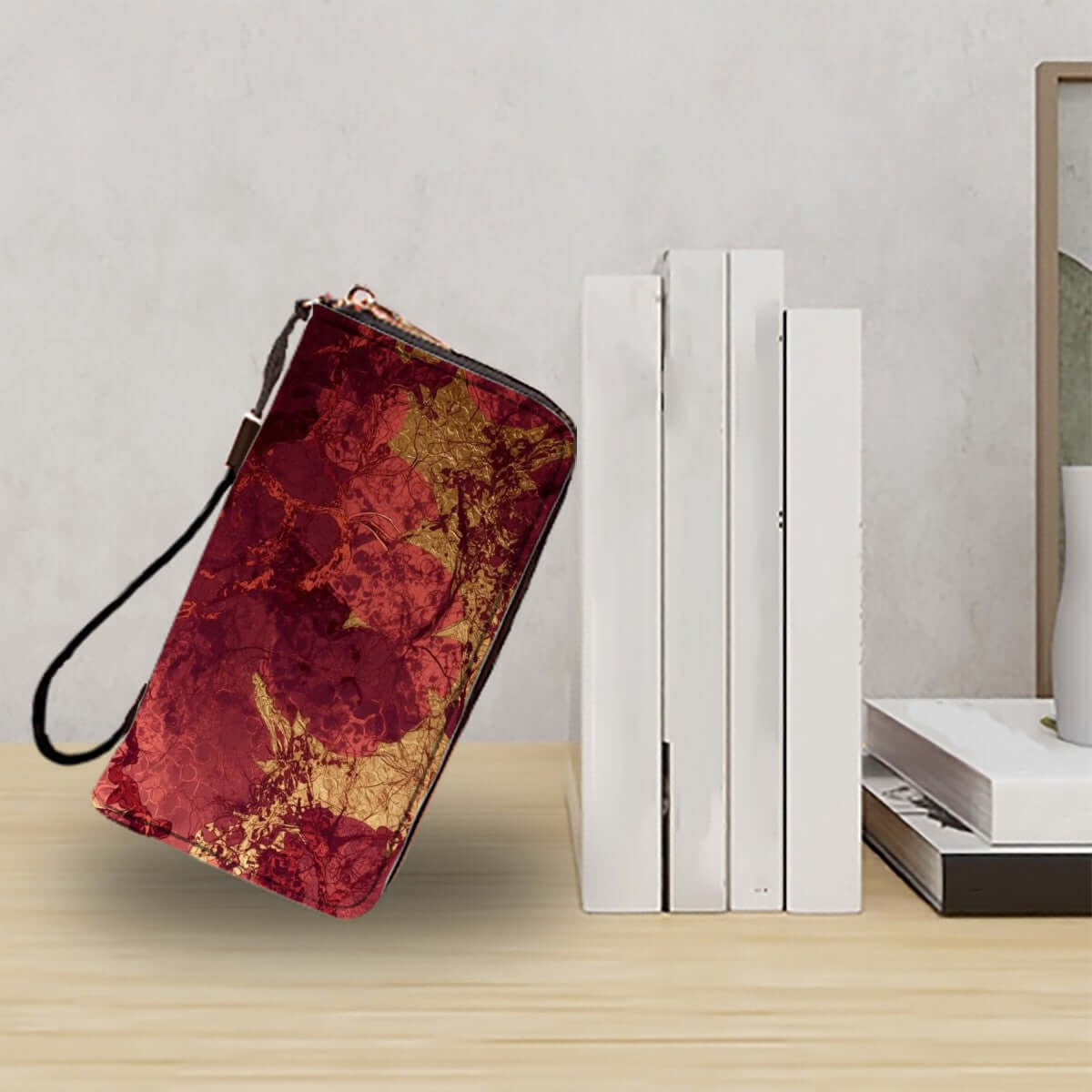 Clutch-Geldbörse für Damen aus PU-Material mit doppelseitigem Druck in Rot-Gold, auf einem Tisch neben weißen Büchern präsentiert.