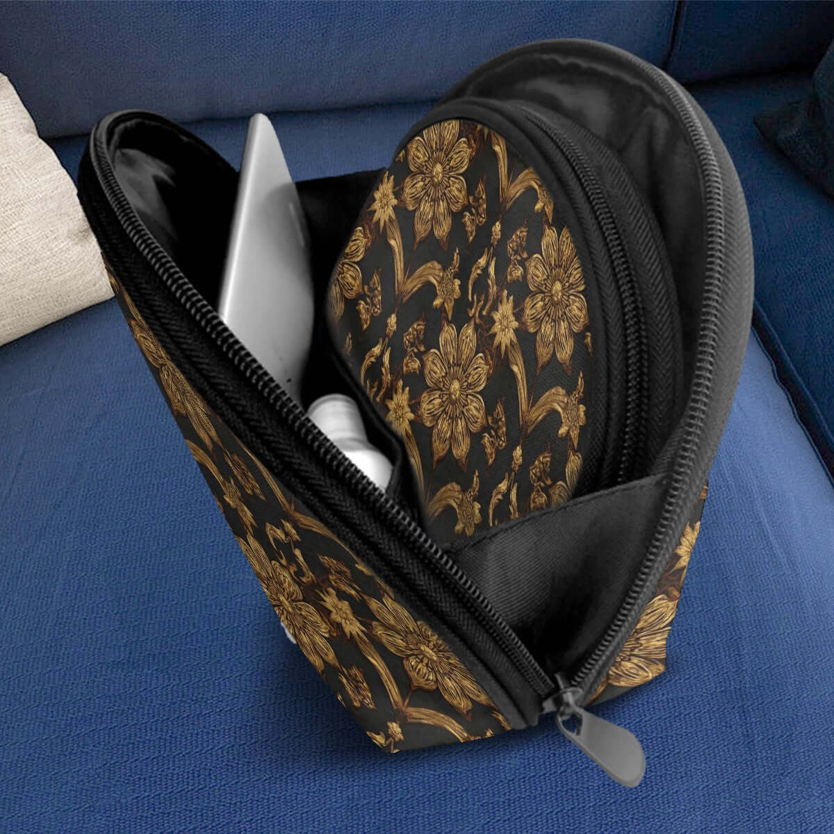 Open black and gold floral storage bag showing interior pockets on a blue sofa, part of Storage Bags Set of 2, PU-Tragetasche für Damen.