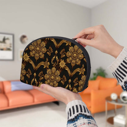 Person holding a large floral Storage Bags Set of 2 with black and gold design in a living room, featuring zipper closure and spacious interior.