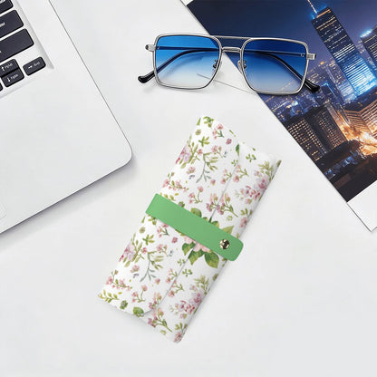 Brillenetui aus PU-Leder mit floralem Design neben Laptop und Sonnenbrille, ideal für kratzfreien Schutz von Brillen.