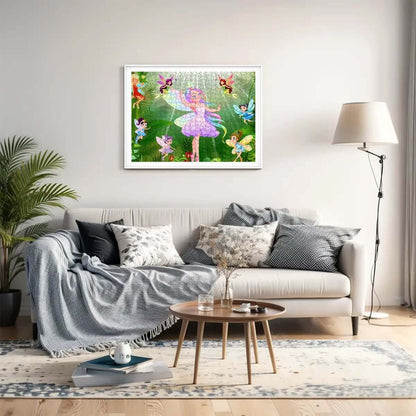 Living room with a cozy gray sofa and decorative framed artwork featuring fairies, creating a whimsical and inviting space.