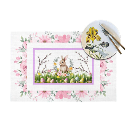 Tischset aus gewebtem PVC mit Hasen- und Blumenmuster, ideal für Osterdekorationen. Enthält Teller-Set als dekorative Ergänzung.