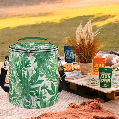 Camping‑Kühltasche grün mit tropischem Print, tragbar, isoliert, wasserdicht, ideal für Outdoor-Picknicks, auf Picknickdecke.