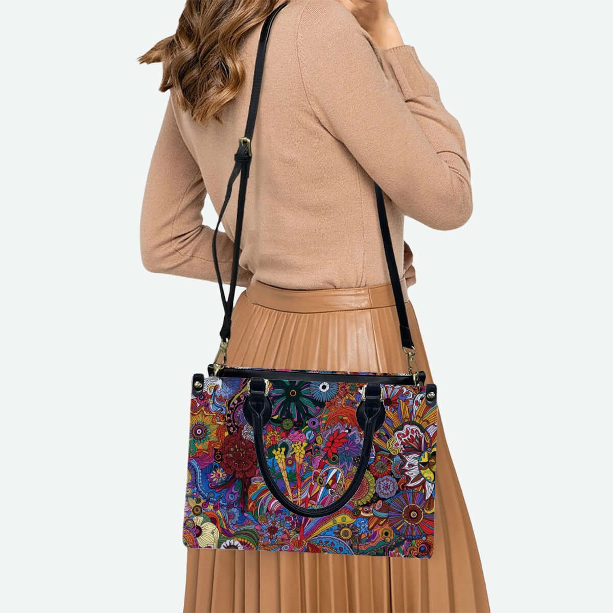 Woman wearing PU Tote Bag for Women with colorful pattern design, black handles and strap, showcasing style and versatility.